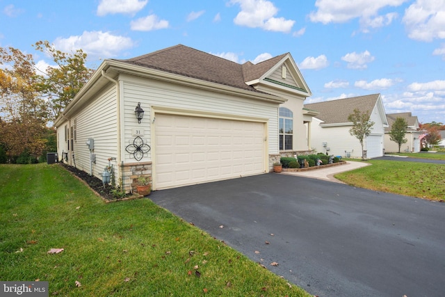 view of front of house with a front yard, a garage, and cooling unit