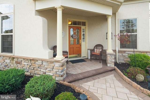 view of exterior entry with covered porch