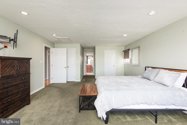 bedroom with a textured ceiling and dark carpet