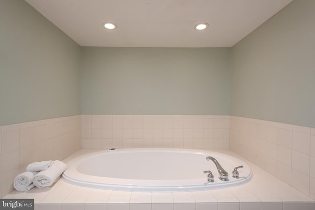 bathroom with a relaxing tiled tub