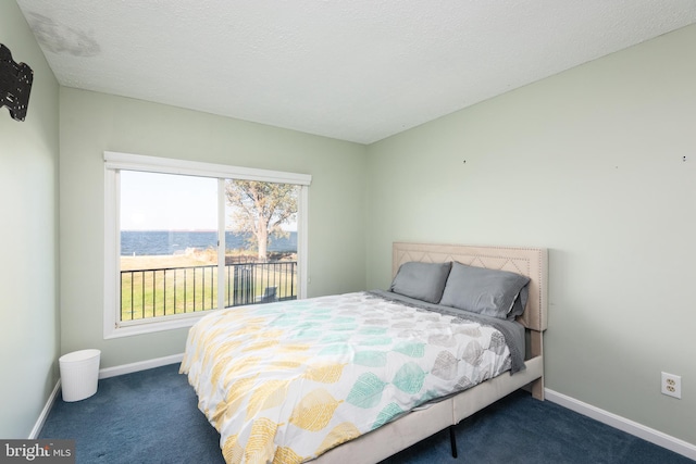 carpeted bedroom featuring a textured ceiling