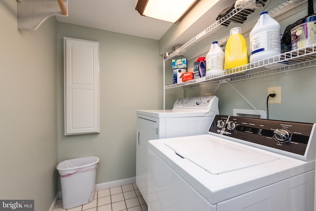 washroom with washer and dryer and light tile patterned flooring