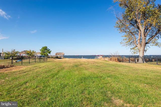 view of yard with a water view and a rural view