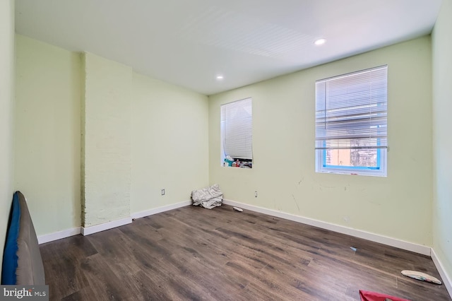 empty room featuring dark hardwood / wood-style flooring