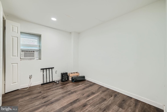 empty room featuring cooling unit and dark hardwood / wood-style floors