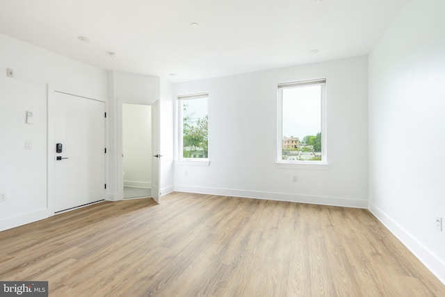 unfurnished room with light hardwood / wood-style floors