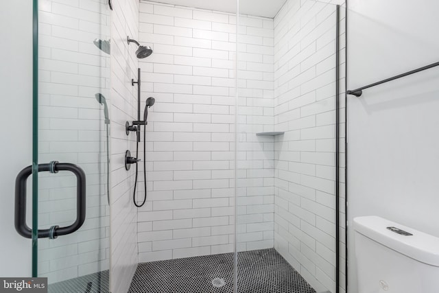 bathroom with toilet and an enclosed shower