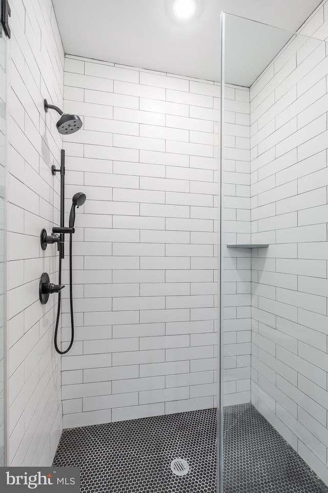 bathroom with a tile shower