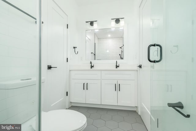 bathroom featuring vanity, tile patterned floors, toilet, and an enclosed shower