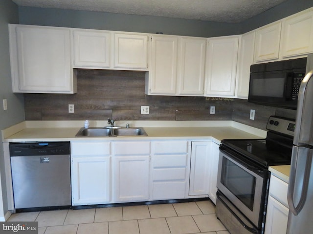 kitchen featuring tasteful backsplash, appliances with stainless steel finishes, sink, a textured ceiling, and white cabinets