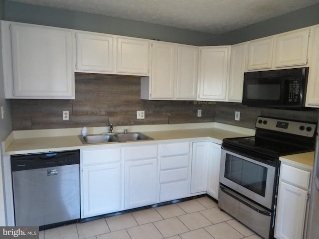 kitchen with decorative backsplash, white cabinets, a textured ceiling, sink, and stainless steel appliances