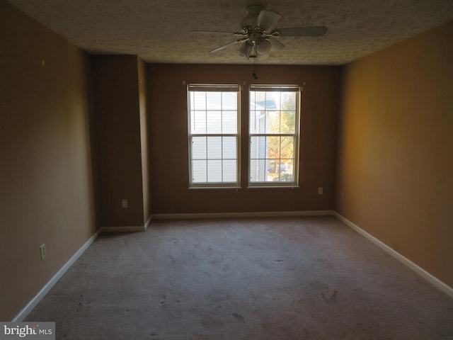 unfurnished room featuring light carpet, a textured ceiling, and ceiling fan