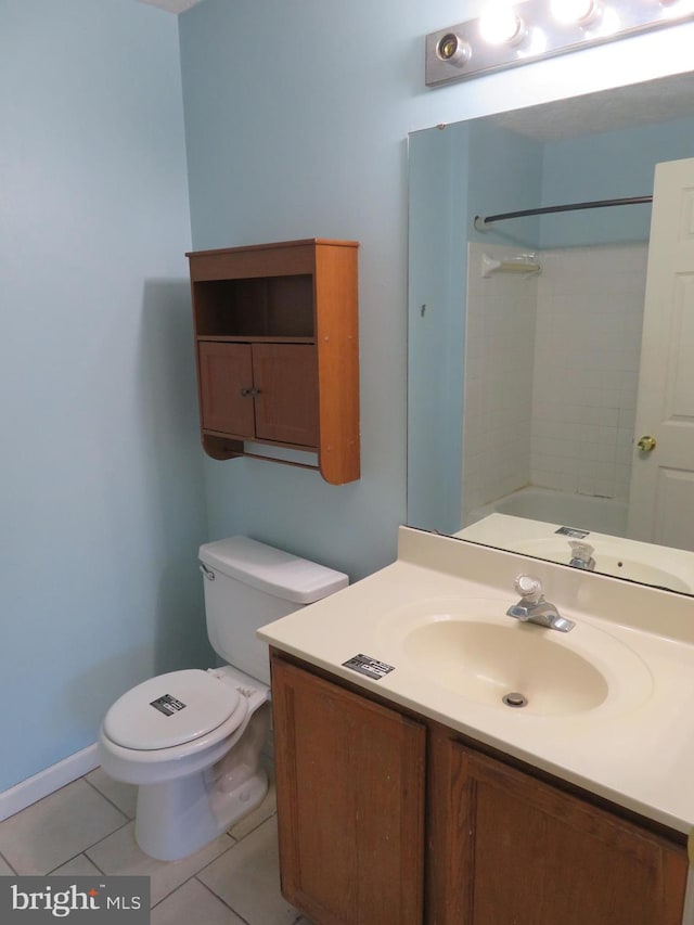 bathroom featuring toilet, walk in shower, vanity, and tile patterned flooring