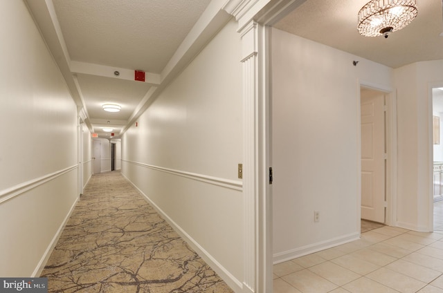 hallway with a textured ceiling