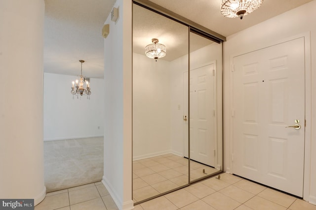 interior space with a chandelier and a textured ceiling