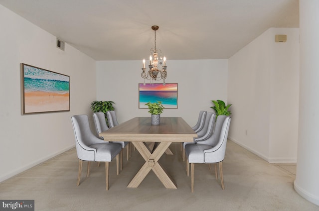 dining area featuring light colored carpet and a chandelier