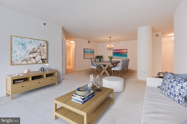 living room with a notable chandelier and light colored carpet