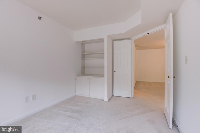 unfurnished bedroom featuring light colored carpet