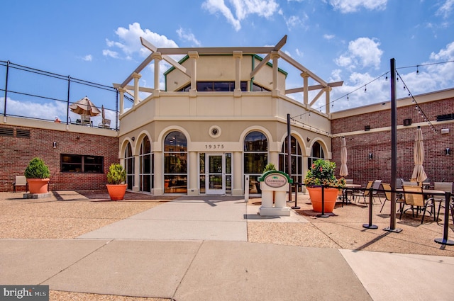 exterior space with a balcony, french doors, and a patio area