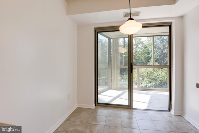 doorway to outside with light tile patterned floors