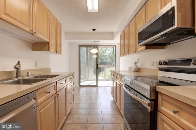 kitchen featuring light tile patterned floors, appliances with stainless steel finishes, a textured ceiling, sink, and decorative light fixtures