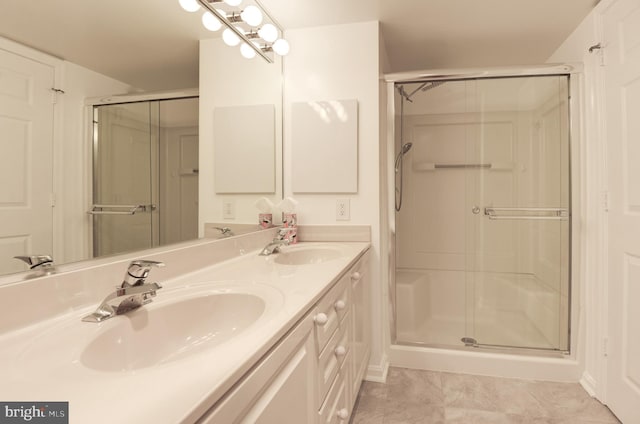 bathroom featuring vanity, a shower with shower door, and tile patterned flooring