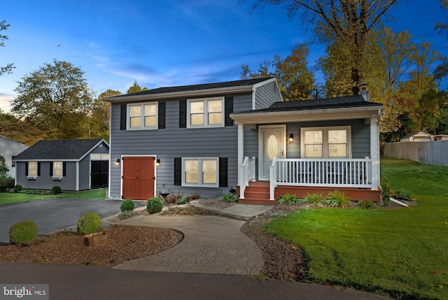 split level home with covered porch and a yard