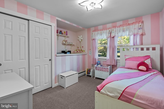 bedroom featuring a closet, baseboard heating, and carpet