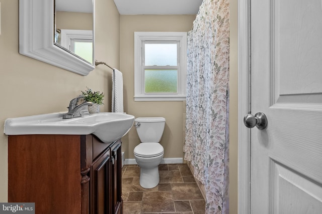 bathroom featuring vanity, a shower with curtain, and toilet