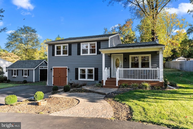 split level home with covered porch, a front yard, and a shed