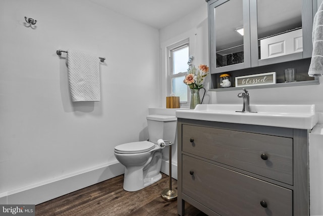 bathroom with vanity, hardwood / wood-style flooring, and toilet