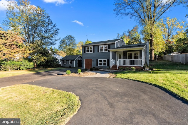 tri-level home with a porch and a front yard