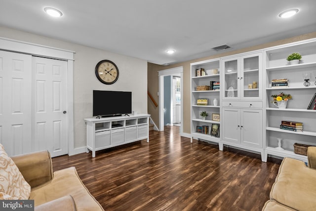 living room with dark hardwood / wood-style flooring