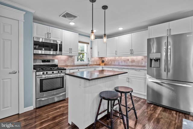 kitchen featuring a center island, white cabinets, and stainless steel appliances