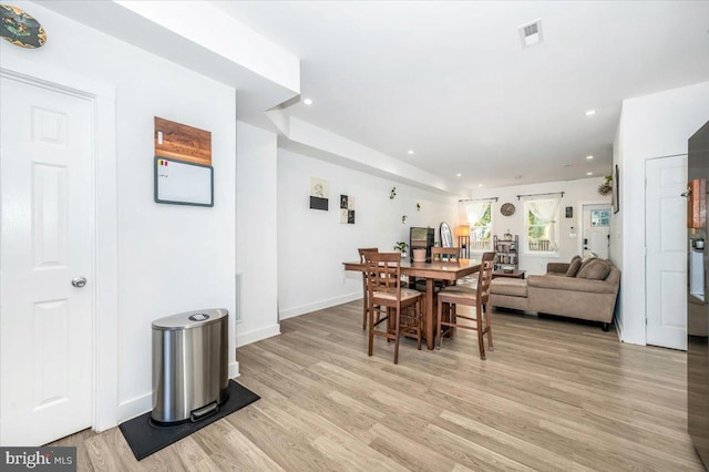 dining space with light wood-type flooring