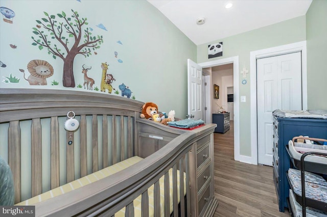 bedroom with dark wood-type flooring and a closet