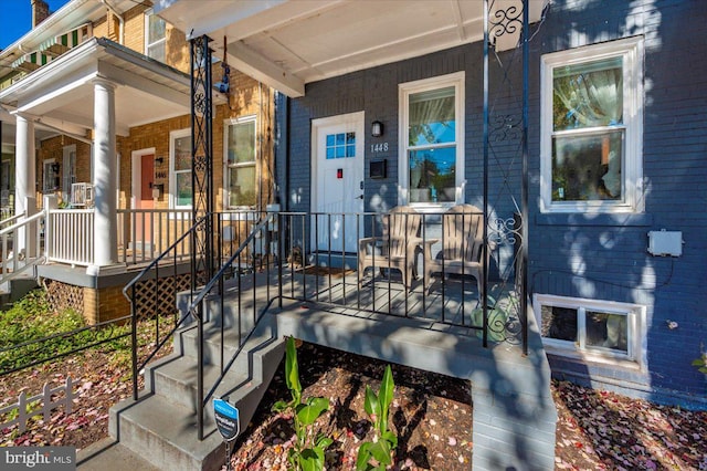 entrance to property featuring a porch