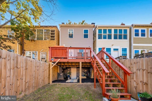 rear view of property featuring a wooden deck and central air condition unit