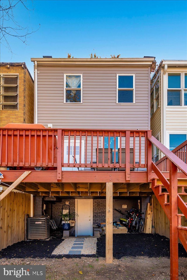 rear view of property with a deck and central air condition unit