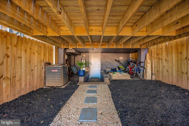 interior space with wood walls, brick wall, and carpet