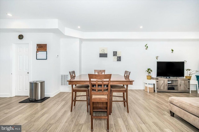 dining space with light hardwood / wood-style floors