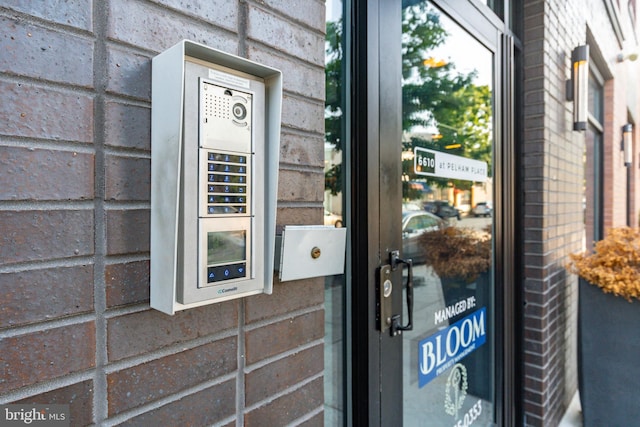 view of exterior entry with electric panel