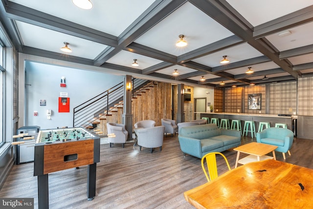 playroom with beam ceiling, wood finished floors, and coffered ceiling