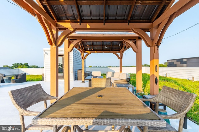 view of patio with a gazebo and outdoor dining area