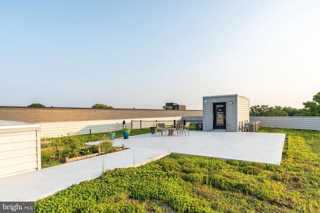view of patio with central AC and fence