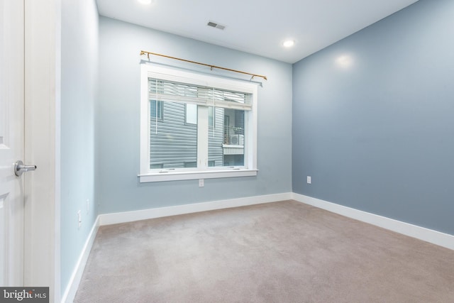 carpeted empty room featuring visible vents, recessed lighting, and baseboards