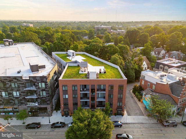 drone / aerial view with a wooded view