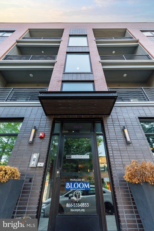 view of outdoor building at dusk