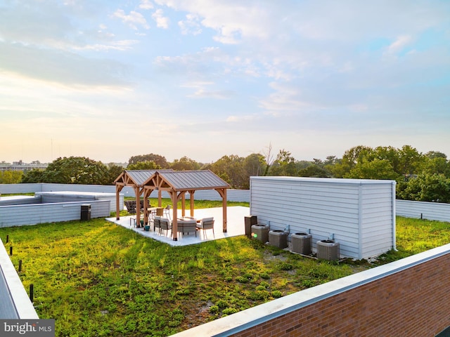 yard at dusk with a patio area and cooling unit