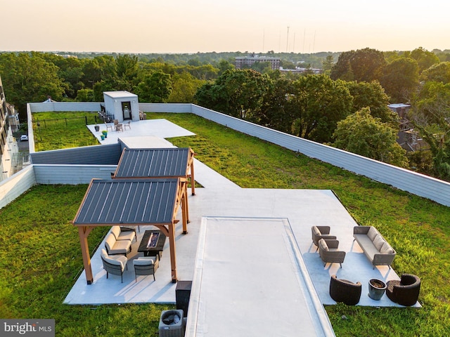 exterior space with an outbuilding, a lawn, a storage unit, and a fenced backyard